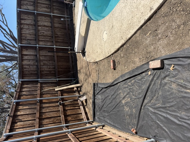 Backyard with bare dirt before turf installation